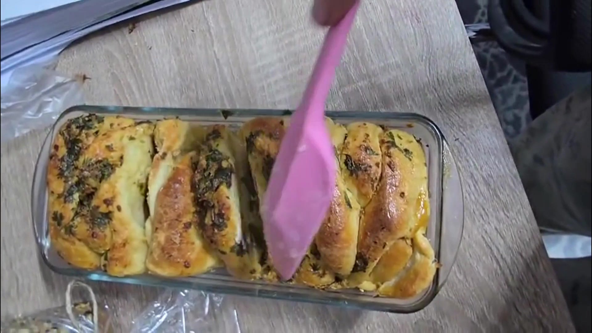 Herb-topped sourdough in a glass baking dish
