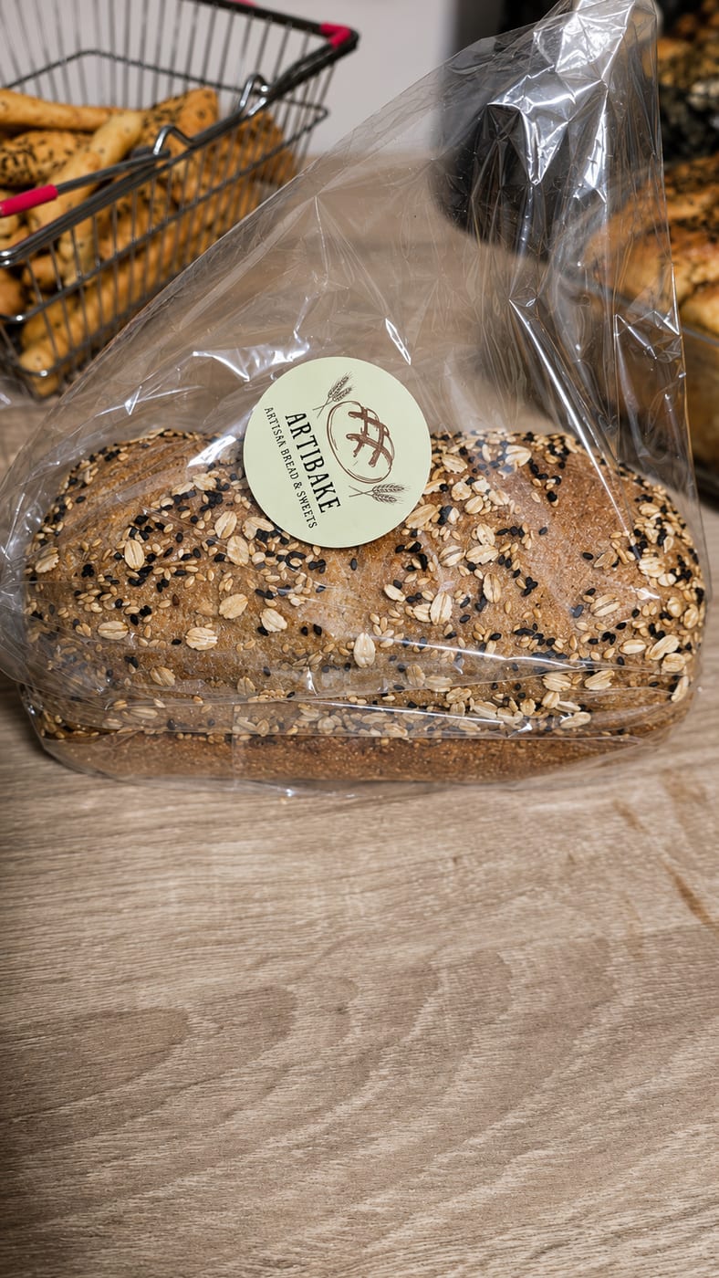 Seeded sourdough loaf in a clear ARTIBAKE bag