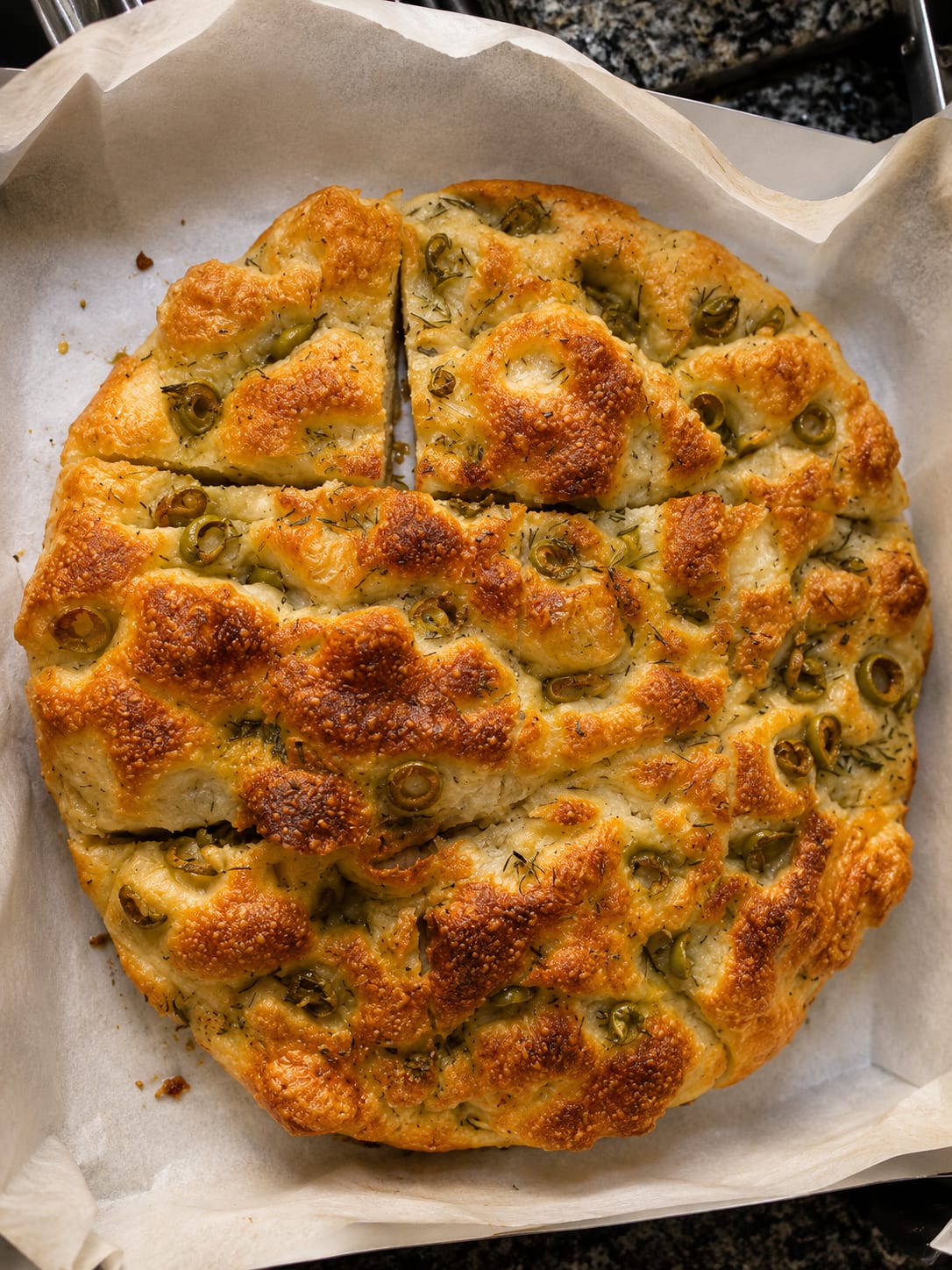 Olive and fresh thyme sourdough focaccia on parchment